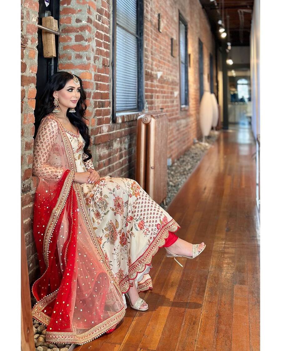 Stylish model showcases FABULOUS GEORGETTE EMBROIDERY SEQUENCE WITH DIAMOND HAND WORK GOWN BOTTOM WITH DUPATTA WHITE.