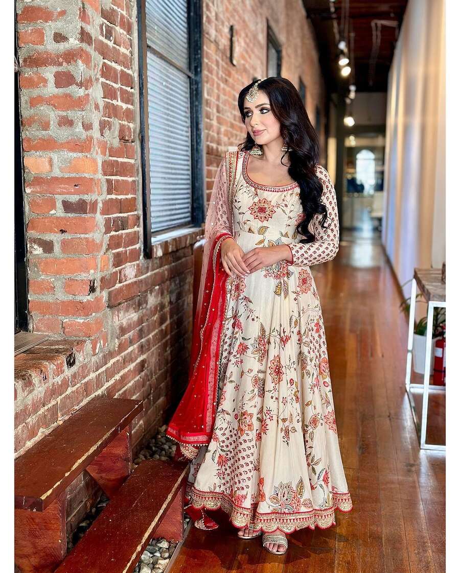 Elegant woman showcasing the fabulous georgette embroidery sequence with diamond hand work gown bottom with dupatta white.